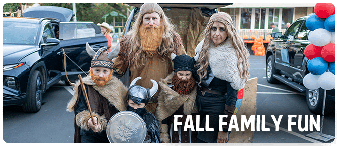Costumed volunteers at a decorated car at Fall Family Fun Trunk-or-Treat